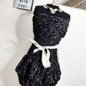Black ruffle cocktail dress with silver accents